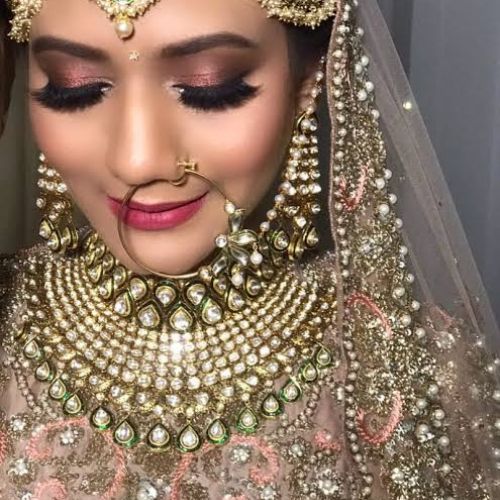 Indian bride in traditional red lehenga with HD bridal makeup by Showstopper by Simran